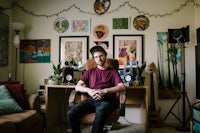 a man sitting in a chair in his living room